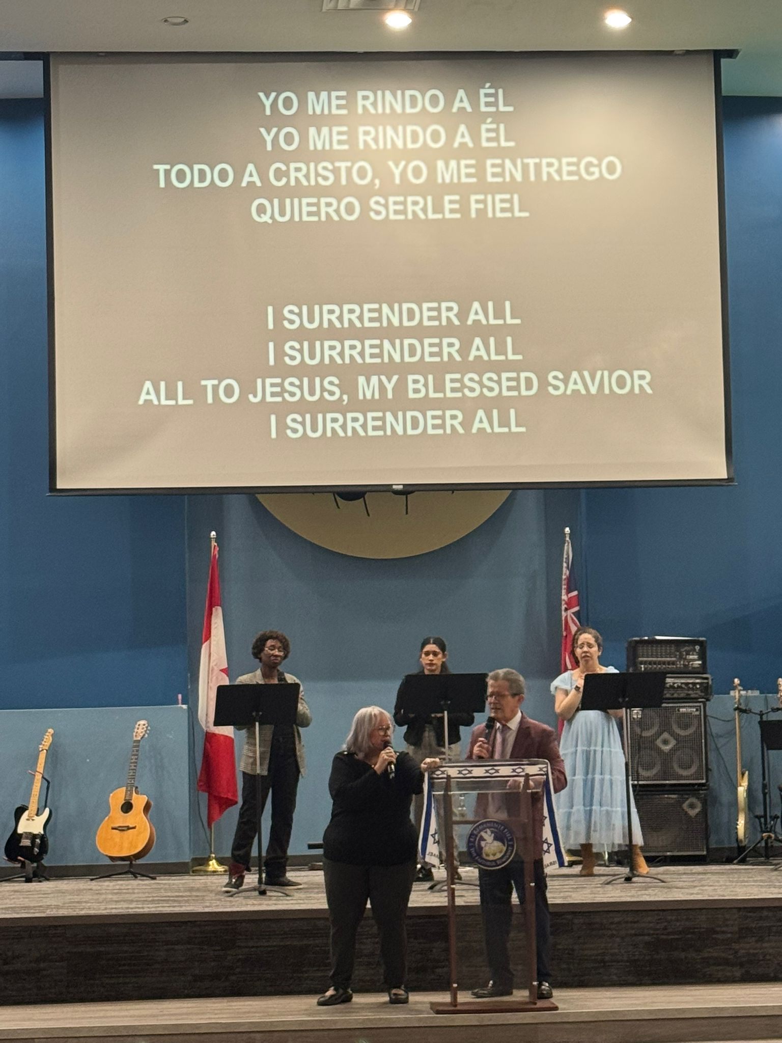 Worship team singing I Surrender All